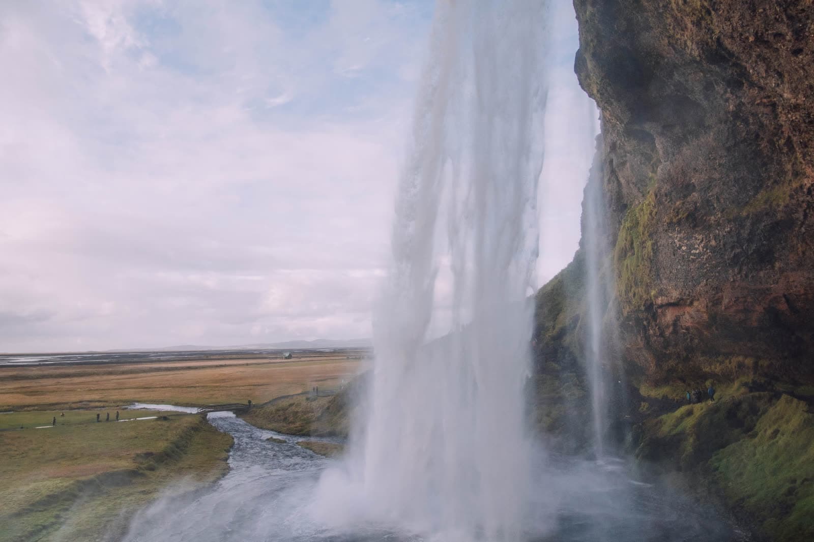 Seljalandsfoss seen from the path that runs behind the falling water.
