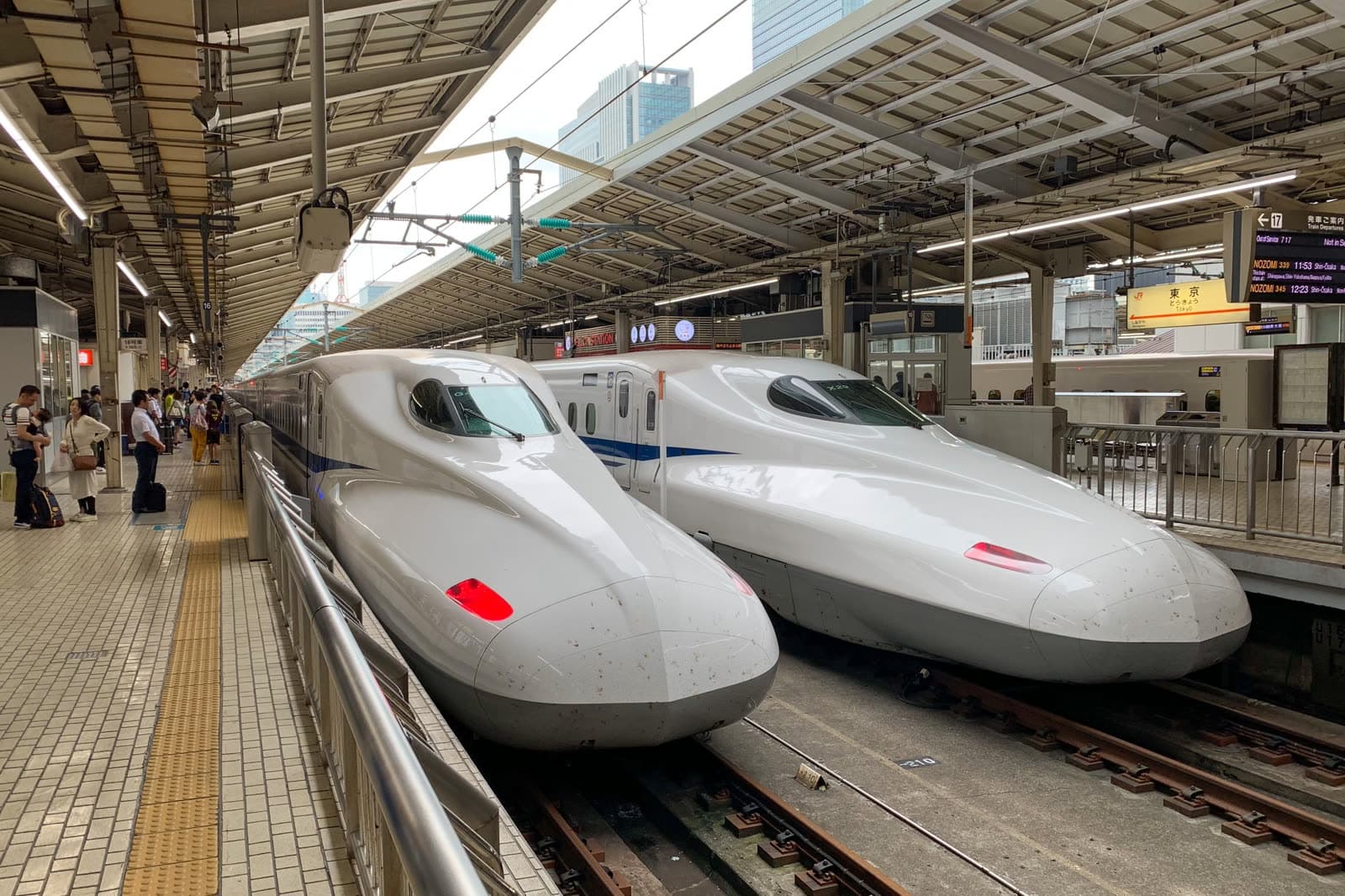 Two bullet trains nose to nose at a Japanese platform.