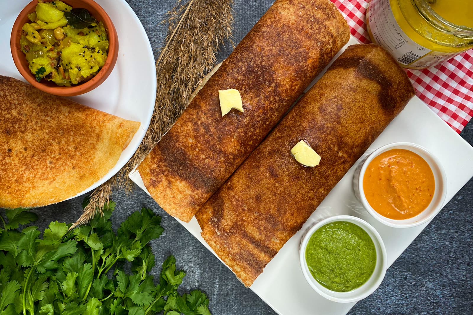 Crisp golden dosas served with coconut and tomato chutneys.